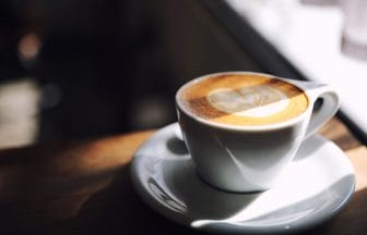cappuccino or Latte art coffee made from milk on the wood table | コーヒーステーション