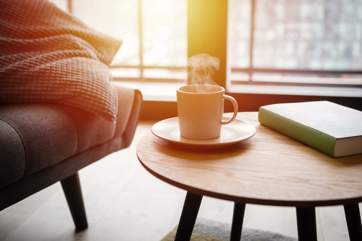 Relax at home cup of hot tea and book on coffee table by the sofa | コーヒーステーション