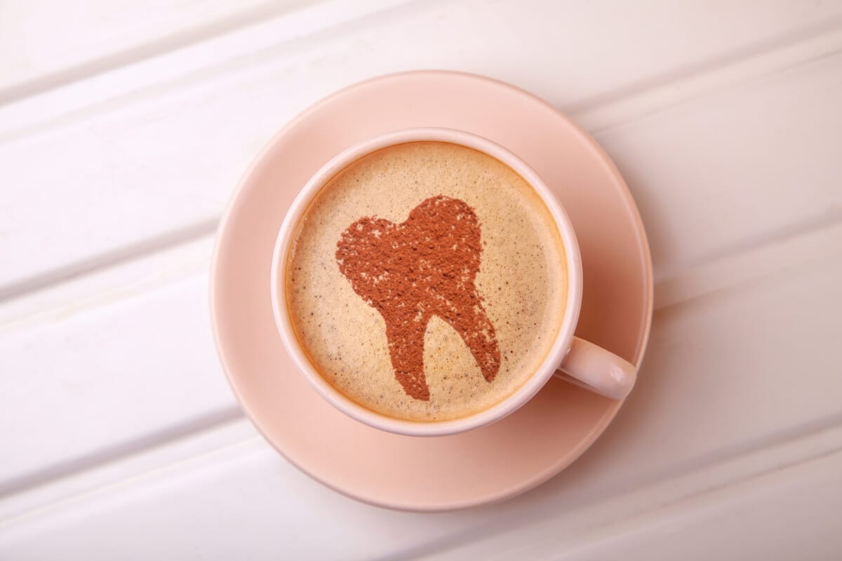 5623205 Cup of coffee with tooth on foam Coffee spoils teeth an | コーヒーステーション