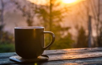 Still life with cup of coffee on the carpathian mountains backgr | コーヒーステーション