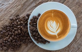 bean coffee with latte art or cappuccino on wooden table | コーヒーステーション